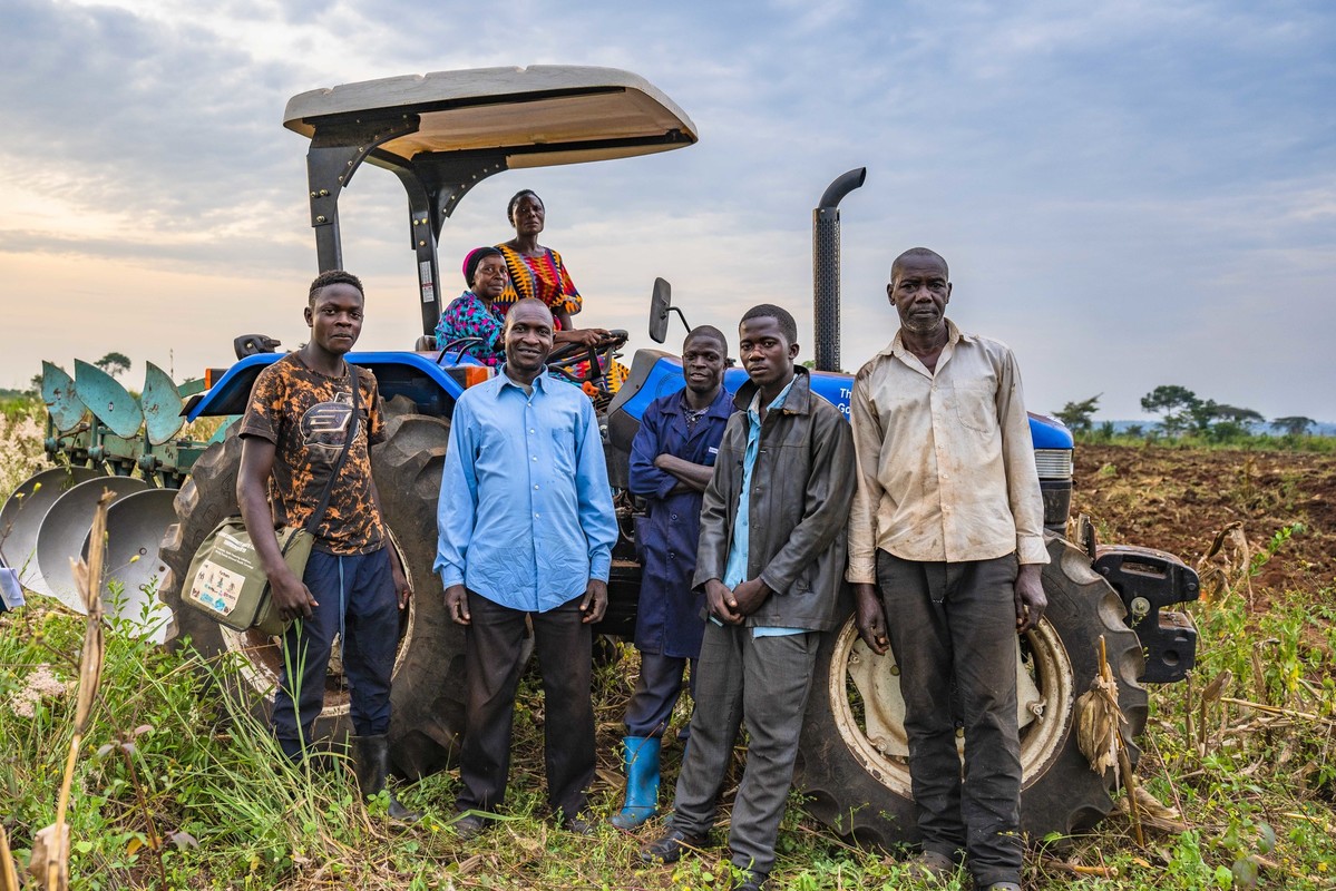 coffee farmers in Uganda in front of their tractor